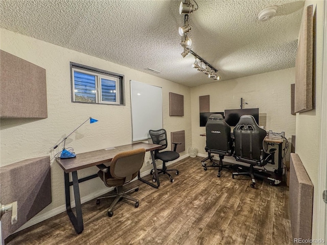 office space with wood finished floors, baseboards, rail lighting, a textured ceiling, and a textured wall