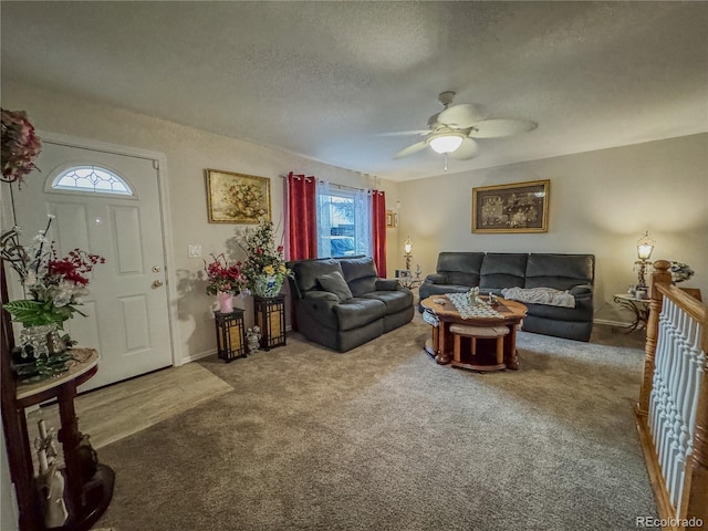 carpeted living area with a textured ceiling and ceiling fan