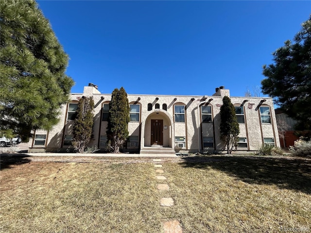 6485 Yvonne Way, Colorado Springs, CO 80918 - view of front of home with stucco siding and a front lawn