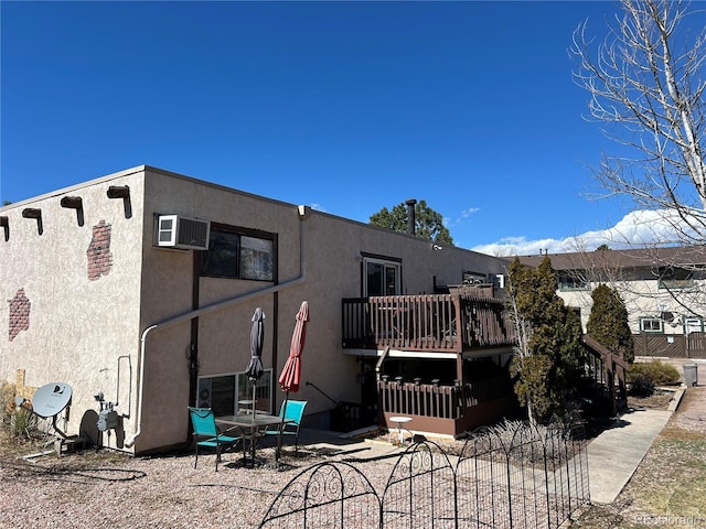 6485 Yvonne Way, Colorado Springs, CO 80918 - rear view of property featuring stucco siding and an AC wall unit
