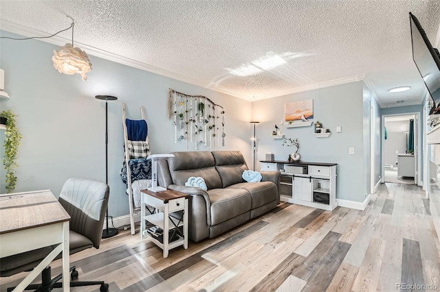 living room with crown molding, a textured ceiling, and light wood-type flooring