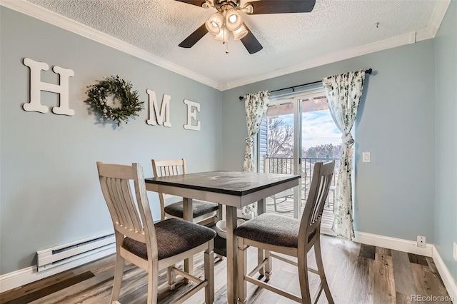 dining room featuring wood-type flooring, ornamental molding, ceiling fan, and a textured ceiling