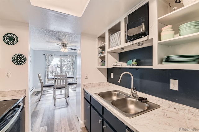 kitchen featuring sink, ceiling fan, light hardwood / wood-style floors, a textured ceiling, and stainless steel electric range oven