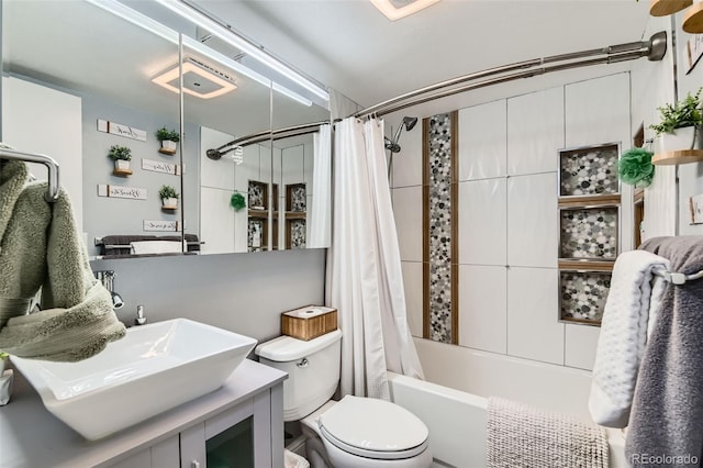 full bathroom with shower / bathtub combination with curtain, vanity, and toilet