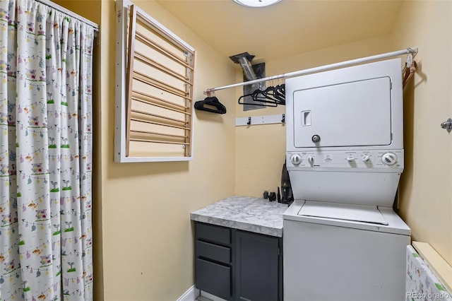 clothes washing area featuring stacked washer / dryer