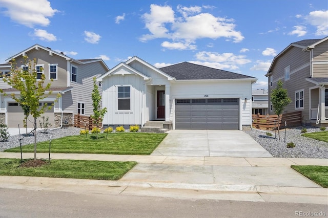 1321 Rock Cliff Ave, Erie, CO 80516 - view of front of property with board and batten siding, an attached garage, driveway, and a front lawn