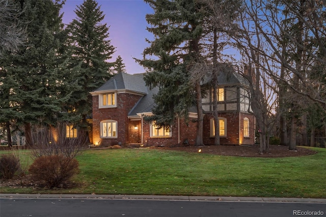 view of front facade featuring a front lawn and brick siding