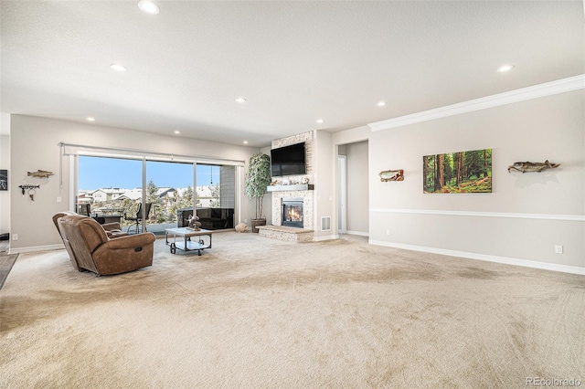 living room with baseboards, a fireplace, recessed lighting, crown molding, and light colored carpet