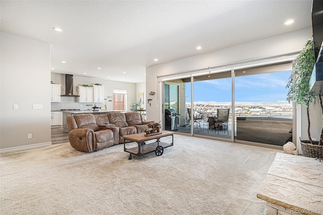 living room with recessed lighting, baseboards, and light carpet