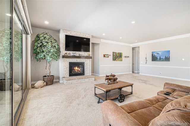 carpeted living room with recessed lighting, baseboards, ornamental molding, and a fireplace