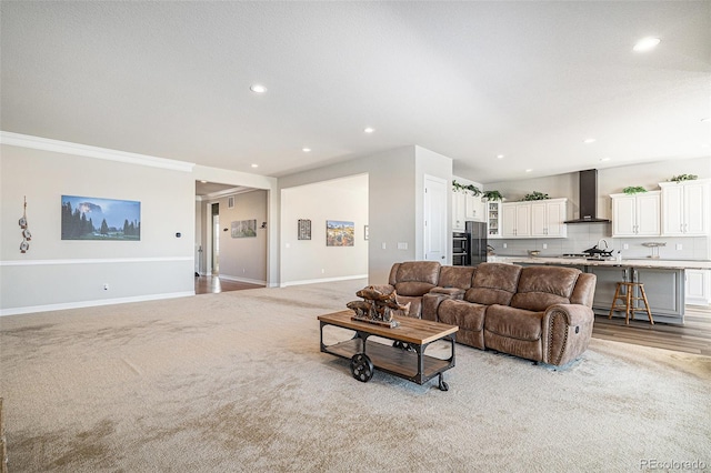 living area with recessed lighting, light colored carpet, and baseboards