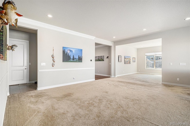 carpeted empty room featuring recessed lighting, baseboards, a textured ceiling, and ornamental molding