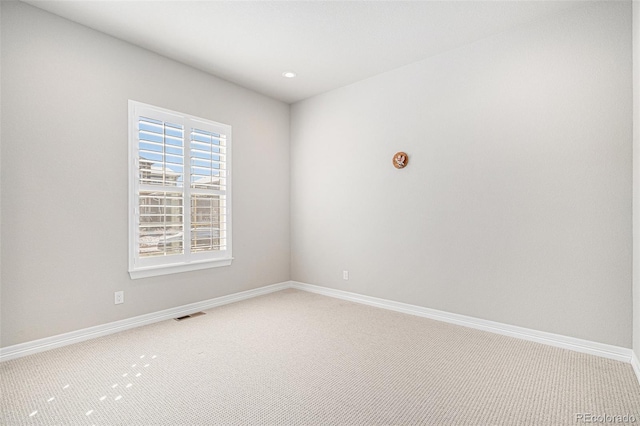 spare room featuring recessed lighting, visible vents, light carpet, and baseboards