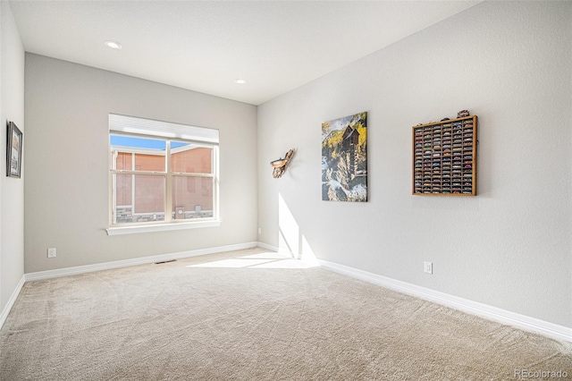 empty room with carpet flooring, recessed lighting, and baseboards