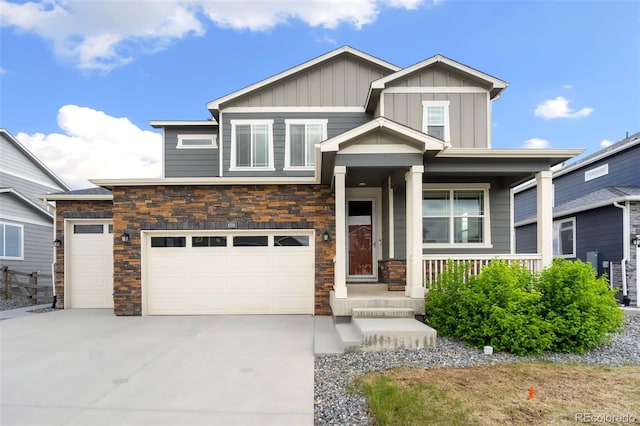 4209 Fox Grove Dr, Fort Collins, CO 80524 - view of front of home featuring board and batten siding, covered porch, stone siding, concrete driveway, and an attached garage