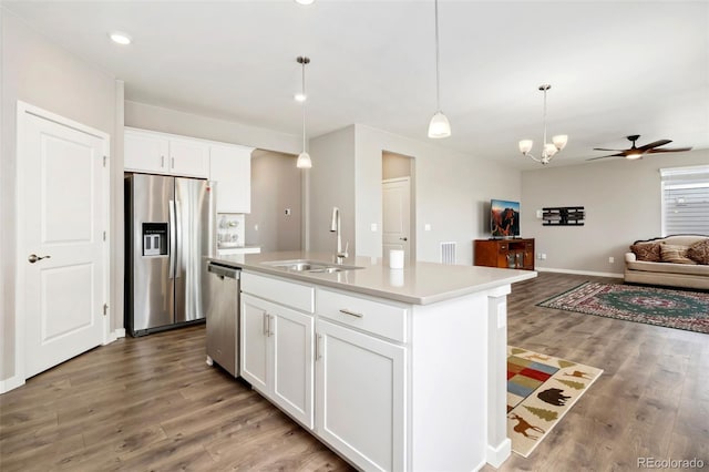 4209 Fox Grove Dr, Fort Collins, CO 80524 - kitchen with appliances with stainless steel finishes, a sink, light wood finished floors, open floor plan, and light countertops