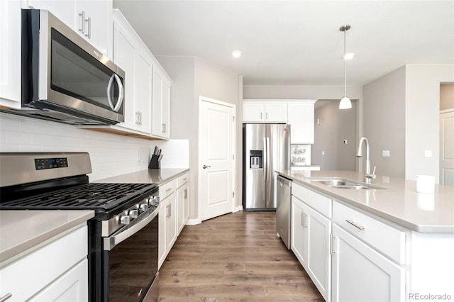 4209 Fox Grove Dr, Fort Collins, CO 80524 - kitchen with appliances with stainless steel finishes, a sink, backsplash, wood finished floors, and light countertops