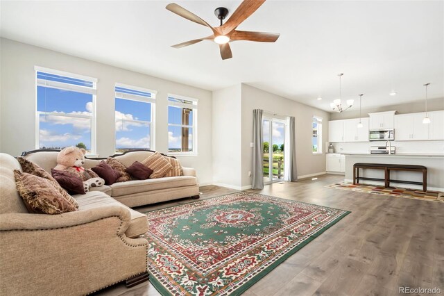 4209 Fox Grove Dr, Fort Collins, CO 80524 - living room with a ceiling fan, light wood-type flooring, baseboards, recessed lighting, and a chandelier