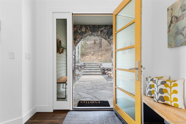 doorway to outside with baseboards and dark wood-style floors