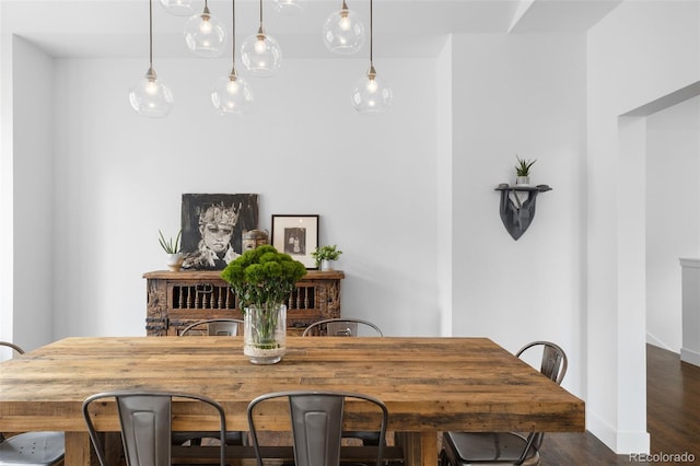 dining area featuring baseboards and dark wood finished floors