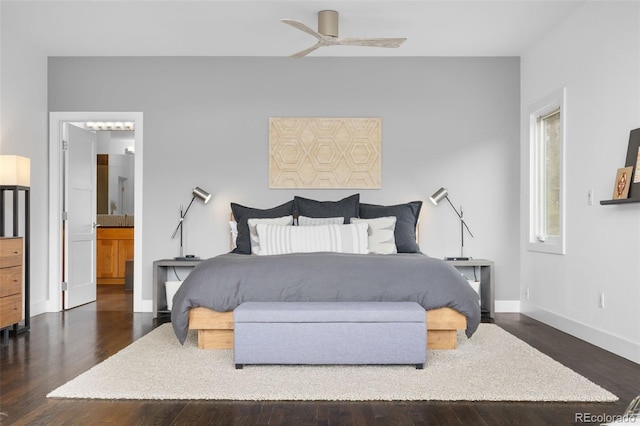 bedroom featuring baseboards, wood finished floors, ensuite bathroom, and a ceiling fan