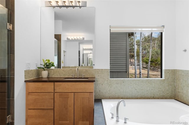 bathroom with vanity and a garden tub
