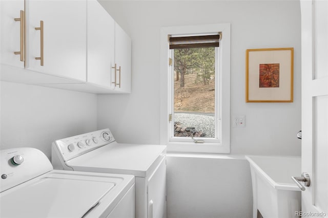 laundry room featuring independent washer and dryer and cabinet space