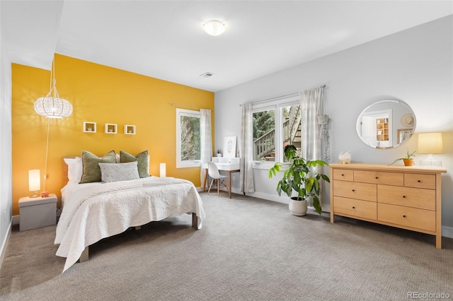 bedroom with baseboards, visible vents, and carpet floors