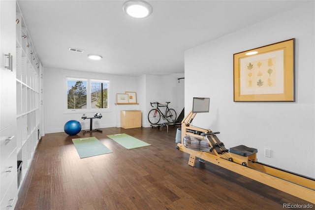 exercise area with visible vents and wood finished floors
