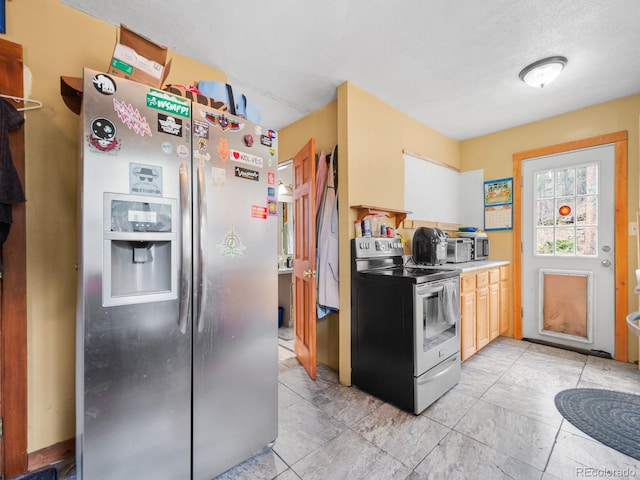 kitchen with appliances with stainless steel finishes and a textured ceiling