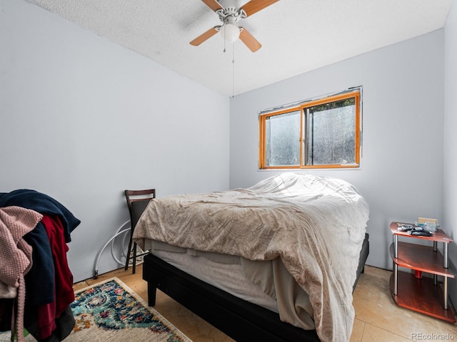 bedroom featuring a textured ceiling and ceiling fan