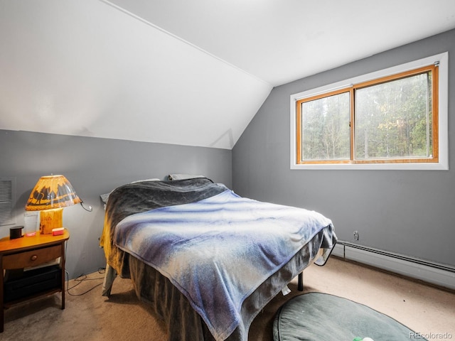 carpeted bedroom with a baseboard heating unit and vaulted ceiling