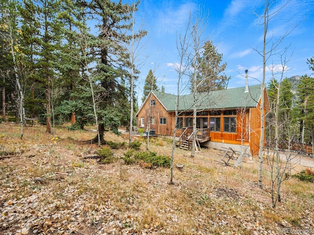 rear view of house featuring a sunroom