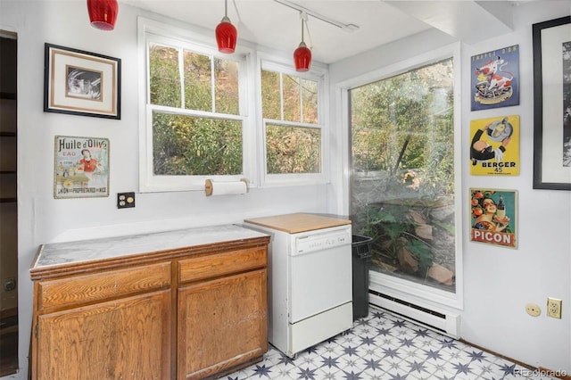 kitchen featuring a wealth of natural light, light floors, brown cabinetry, and a baseboard radiator