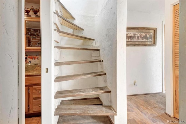 staircase with wood finished floors