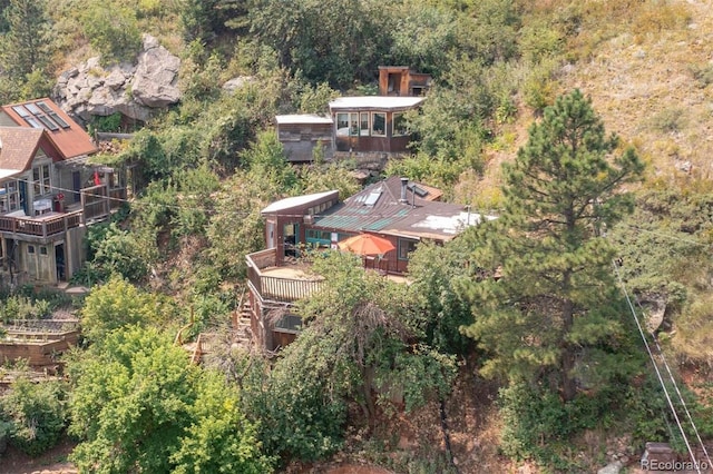 drone / aerial view featuring a wooded view