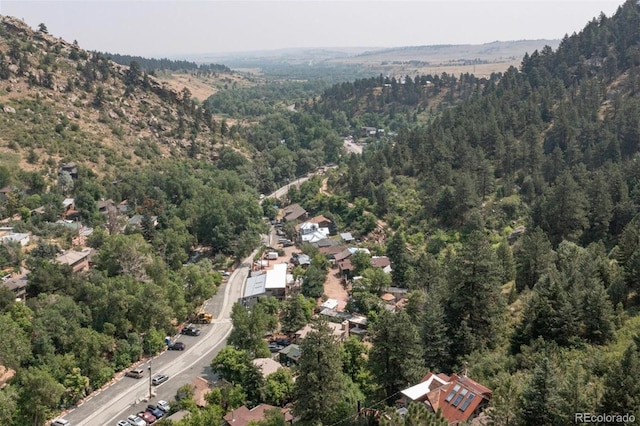 drone / aerial view with a wooded view