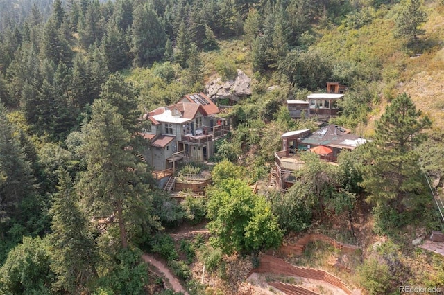 aerial view featuring a wooded view