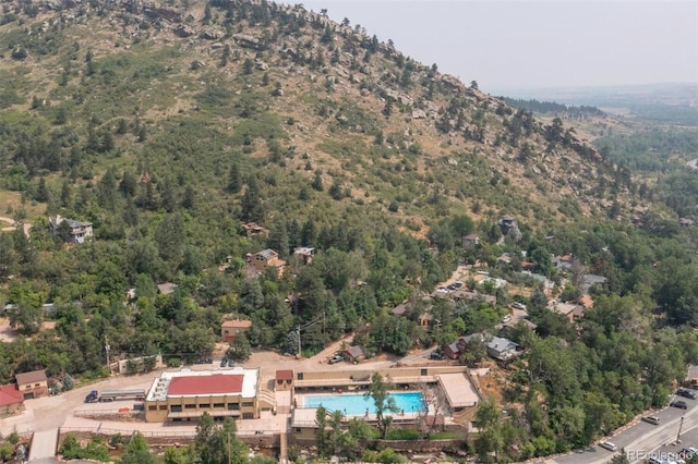 birds eye view of property featuring a view of trees