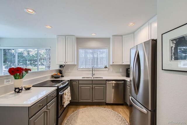 3228 47th, Boulder, CO 80301 - kitchen with stainless steel appliances, gray cabinetry, light wood finished floors, white cabinets, and light countertops