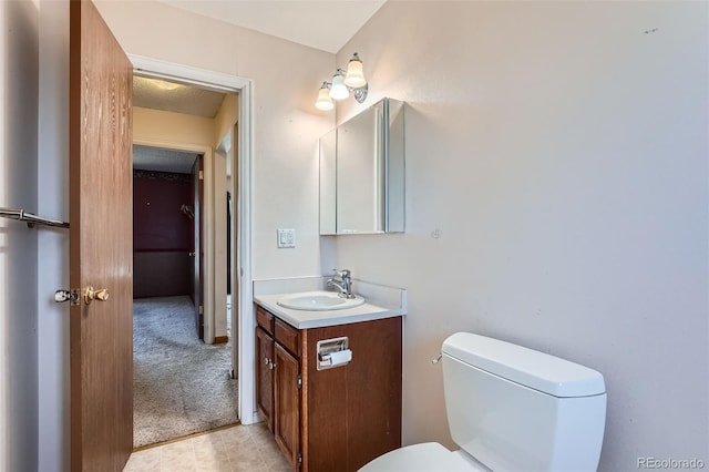 half bath featuring vanity and toilet