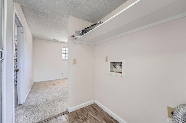 washroom featuring baseboards, a textured ceiling, laundry area, and washer hookup
