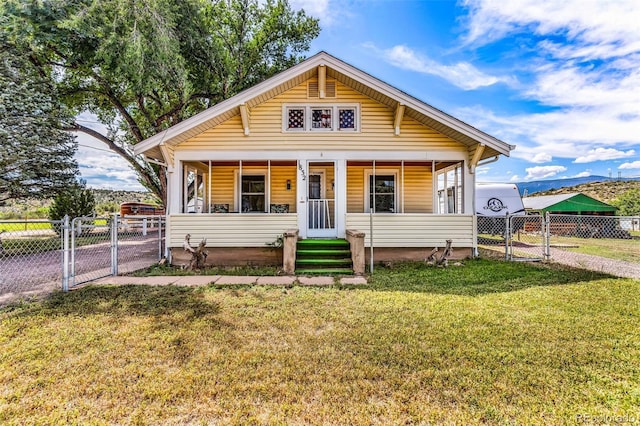 bungalow-style home featuring a front lawn and covered porch