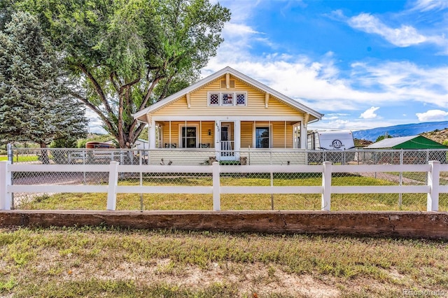 view of front facade with covered porch and a front lawn