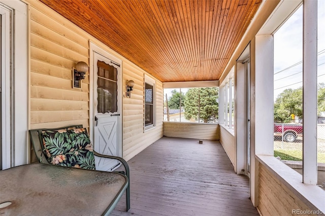 unfurnished sunroom with wooden ceiling