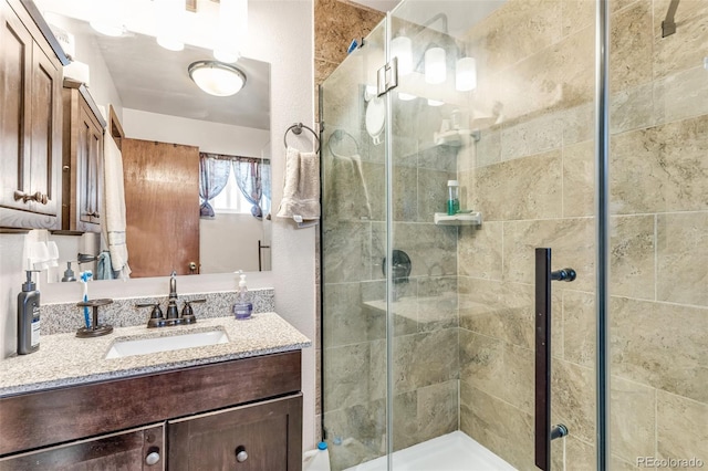 bathroom with vanity and an enclosed shower