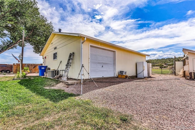 garage featuring cooling unit and white fridge