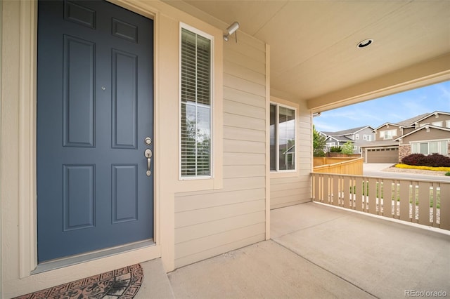 view of exterior entry featuring covered porch