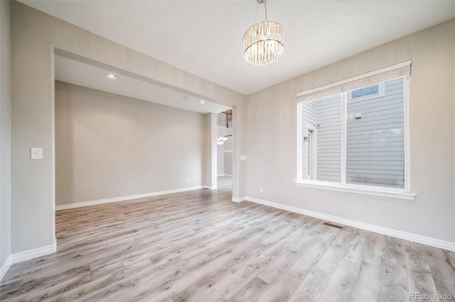 unfurnished room with a chandelier, wood finished floors, and recessed lighting