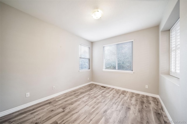 unfurnished room featuring light wood-style floors and baseboards